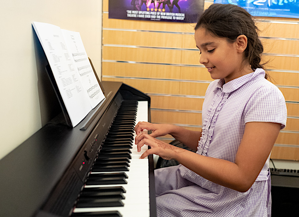 Young girl playing piano.