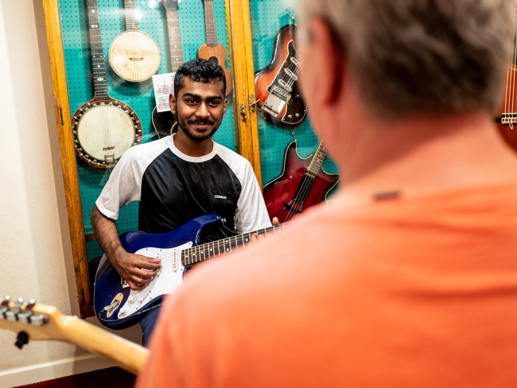 Electric guitar lesson using a stratocaster.