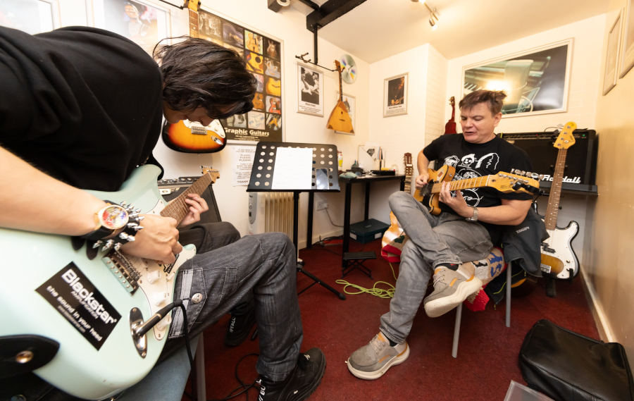 John giving a Guitar Lesson at Booths