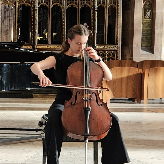 Cello tutor Isla playing Cello in a Church
