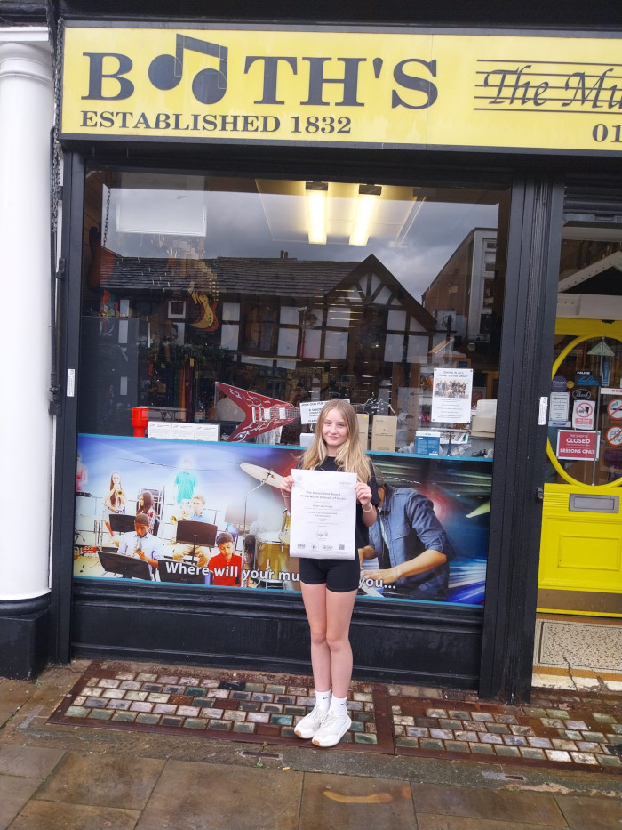 daisy at Booths Music with grade 3 certificate